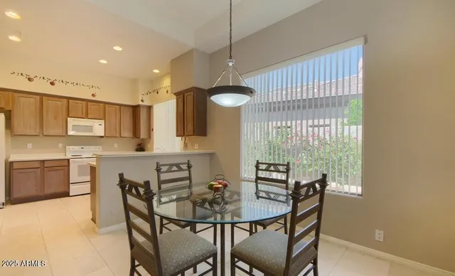 a kitchen with a table and chairs in it