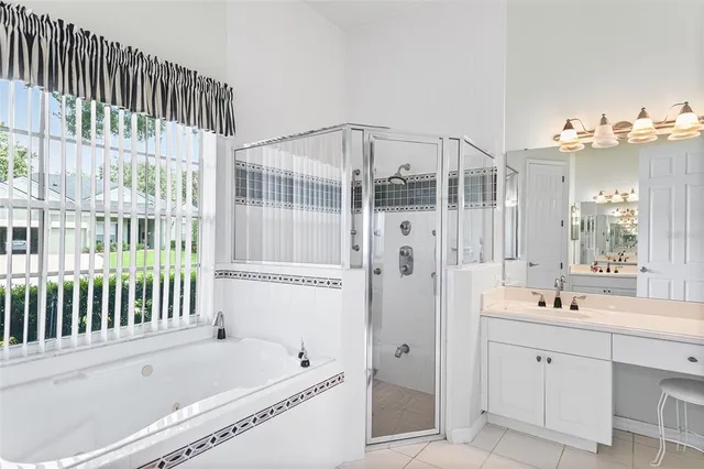 a bathroom with a tub sink and mirror
