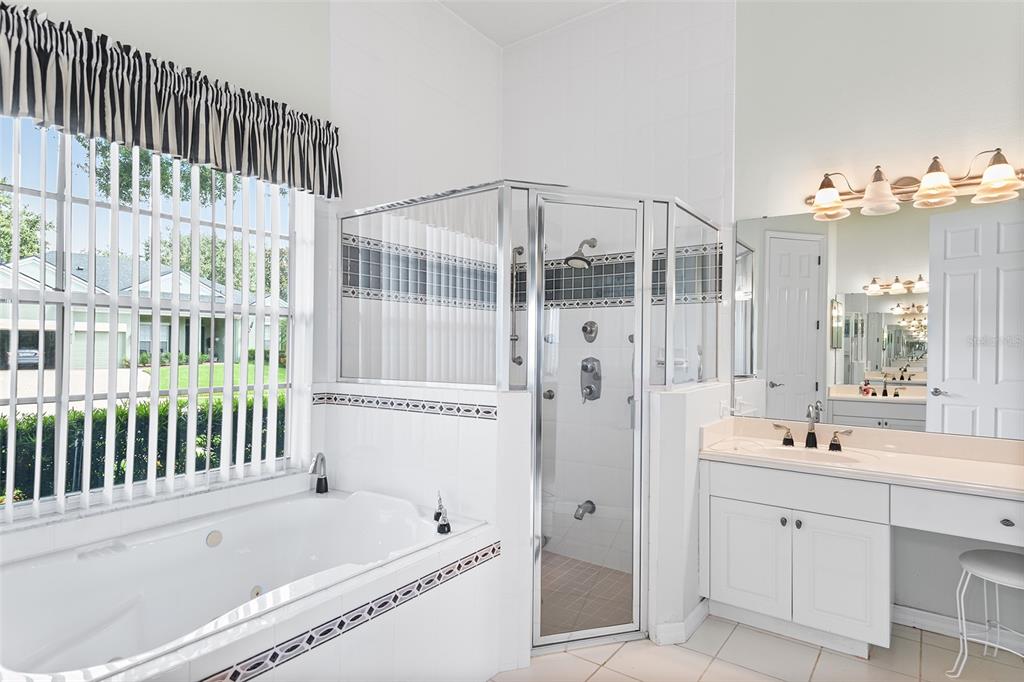 2817 Falcon Ridge Clermont, FL 34711 - Photo 28 of 41 a bathroom with a tub sink and mirror