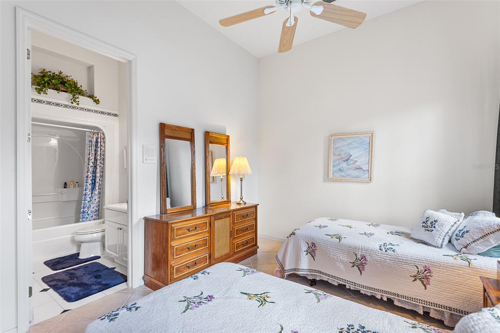 2817 Falcon Ridge Clermont, FL 34711 - Photo 33 of 41 a bedroom with a bed and a chandelier