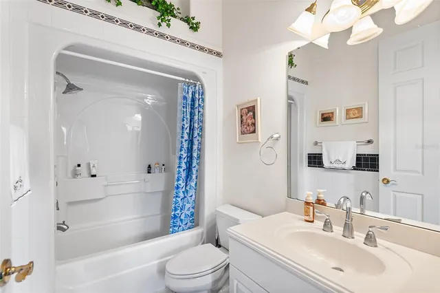 a bathroom with a bathtub shower sink vanity and toilet