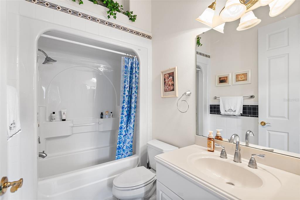 2817 Falcon Ridge Clermont, FL 34711 - Photo 34 of 41 a bathroom with a bathtub shower sink vanity and toilet