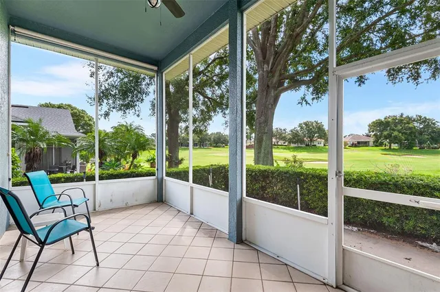 a view of a porch with furniture and garden