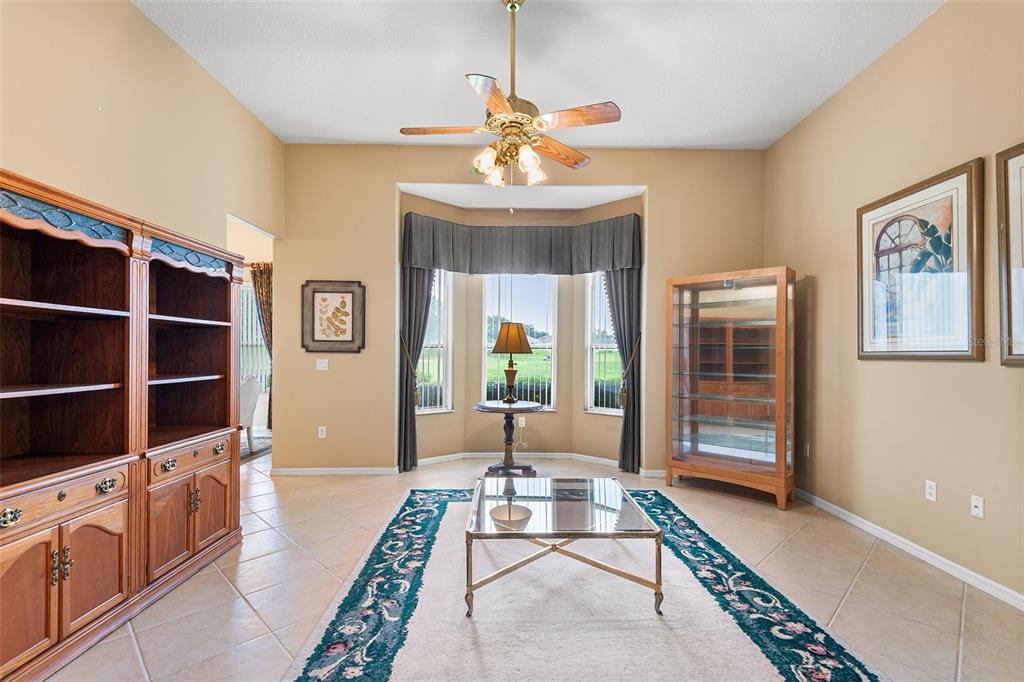 2817 Falcon Ridge Clermont, FL 34711 - Photo 6 of 41 a living room with furniture a window and a chandelier
