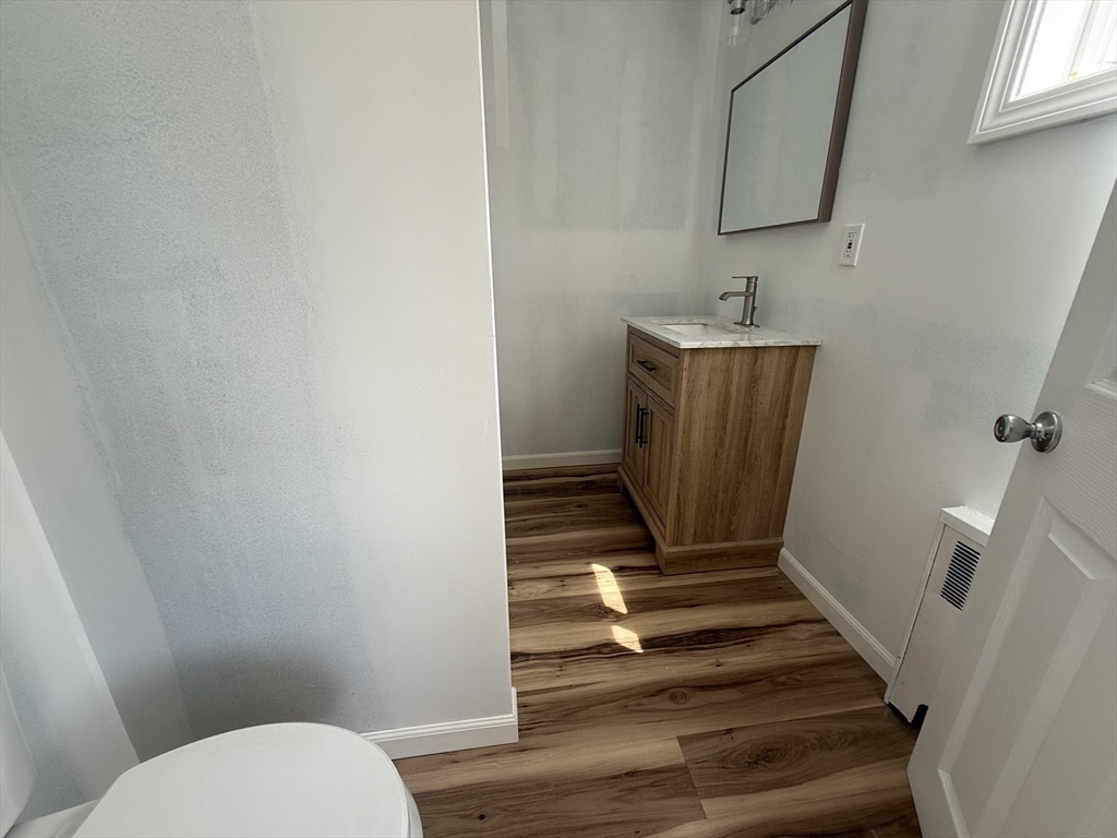 631 Walnut Street, Unit 1 Fall River, MA 02720 - Photo 11 of 12 a bathroom with sink toilet and mirror
