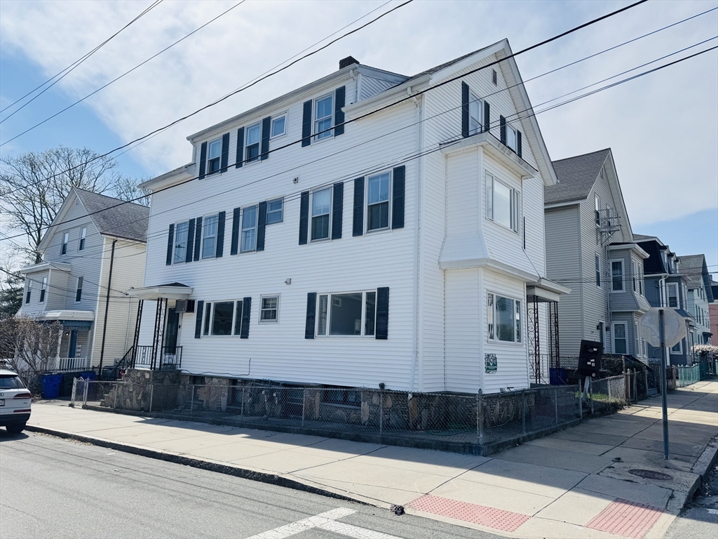 631 Walnut Street, Unit 1 Fall River, MA 02720 - Photo 2 of 12 a view of a white building among the street with buildings