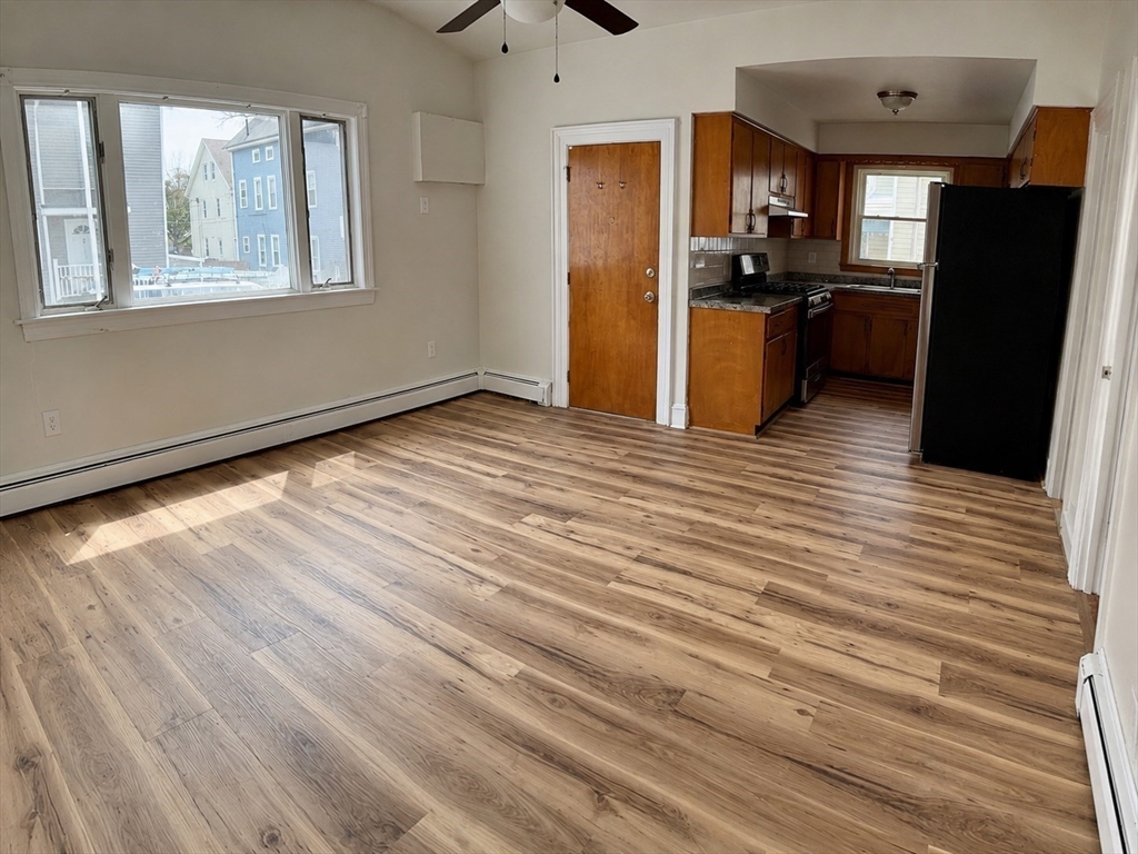 631 Walnut Street, Unit 1 Fall River, MA 02720 - Photo 4 of 12 an empty room with wooden floor and windows