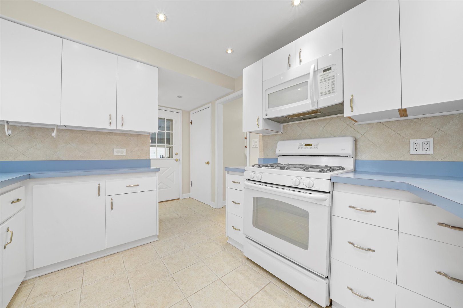 2525 Glenview Road Glenview, IL 60025 - Photo 13 of 50 a kitchen with white cabinets and white appliances