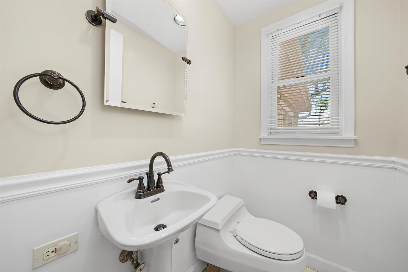 2525 Glenview Road Glenview, IL 60025 - Photo 17 of 50 a bathroom with a sink a toilet and a window