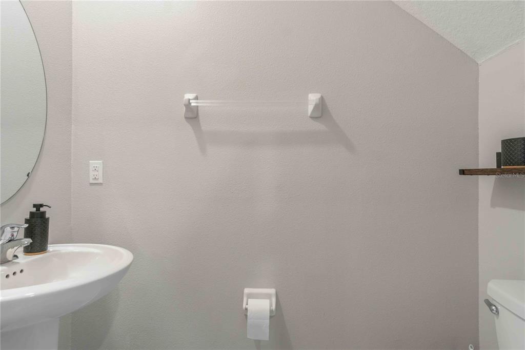 9440 Lemon Drop Loop Sun City Center, FL 33573 - Photo 24 of 55 a bathroom with a sink and mirror