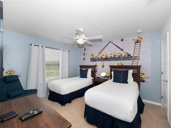 a living room with furniture a flat screen tv and a large window