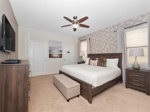 a bathroom with a granite countertop sink a large mirror and a bathtub