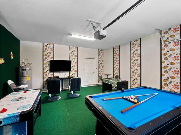 a living room with furniture pool table and a flat screen tv