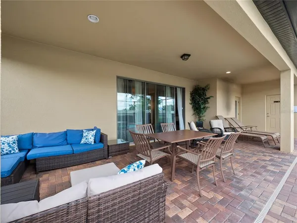 a living room with furniture and a floor to ceiling window