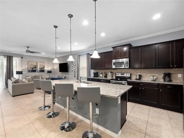 a living room with lots of furniture and a wooden floor