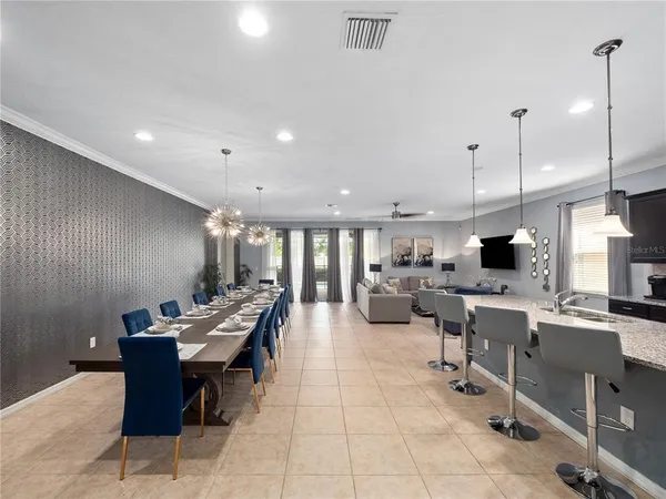 a large kitchen with lots of counter and chairs