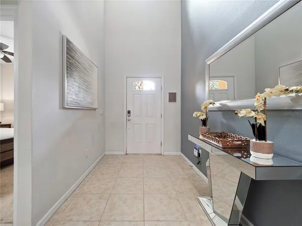 a dining room with furniture a chandelier and kitchen view