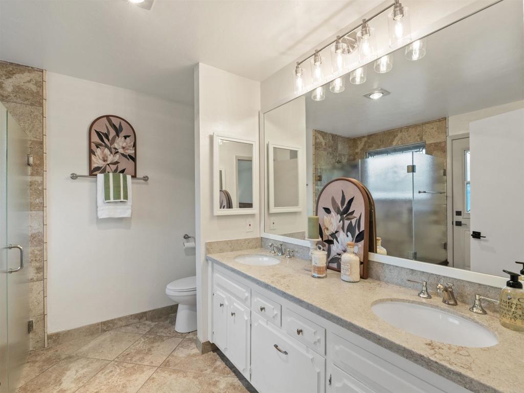 13737 Temple Street Poway, CA 92064 - Photo 19 of 38 a bathroom with a granite countertop double vanity sink and a mirror
