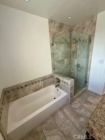 a spacious bathroom with a bath tub and shower