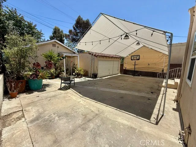 a view of a white house with a outdoor space