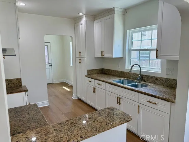 a kitchen with stainless steel appliances granite countertop a sink stove and cabinets