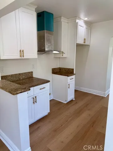 a kitchen with a sink a stove and cabinets