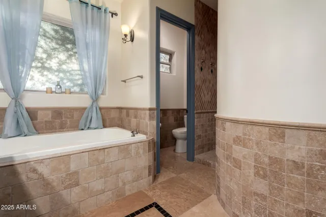 a hallway with sink and cabinets