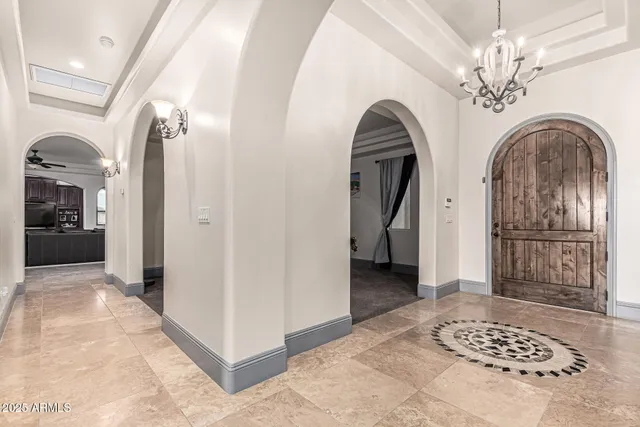 a kitchen with stainless steel appliances granite countertop a sink refrigerator and wooden cabinets