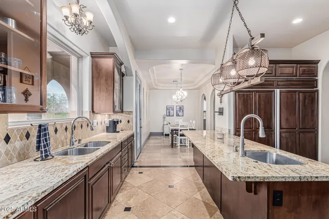 a living room with a bed furniture and a ceiling fan
