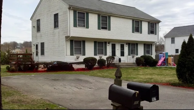 a view of a house with couches in front of house