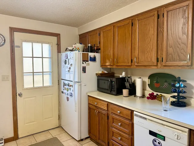 a kitchen with stainless steel appliances granite countertop a refrigerator and cabinets