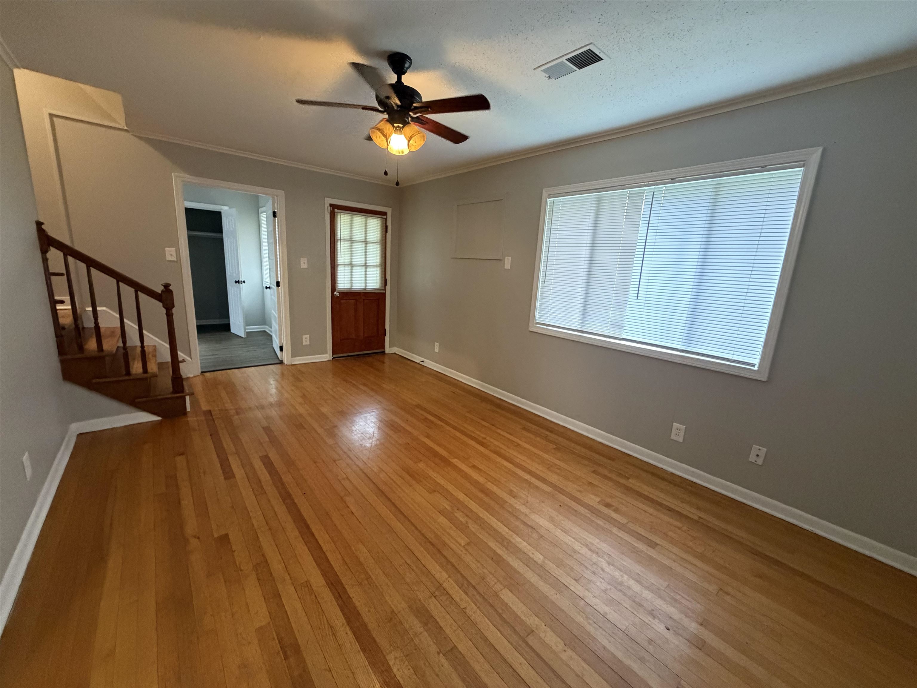 4073 Arrowhead Road Memphis, TN 38118 - Photo 2 of 10 a view of an empty room with wooden floor and a window