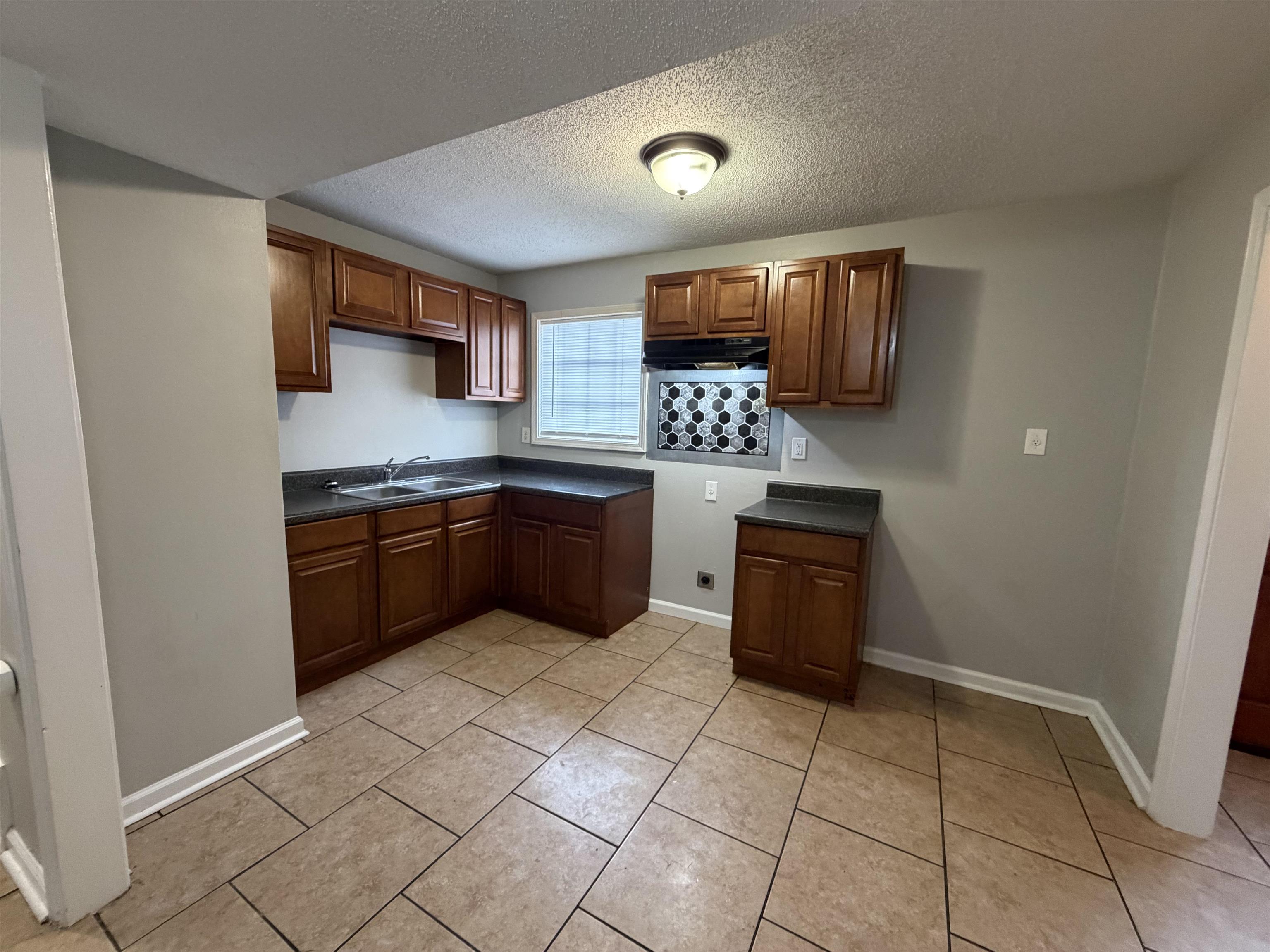 4073 Arrowhead Road Memphis, TN 38118 - Photo 3 of 10 a kitchen with stainless steel appliances kitchen island granite countertop a sink and cabinets