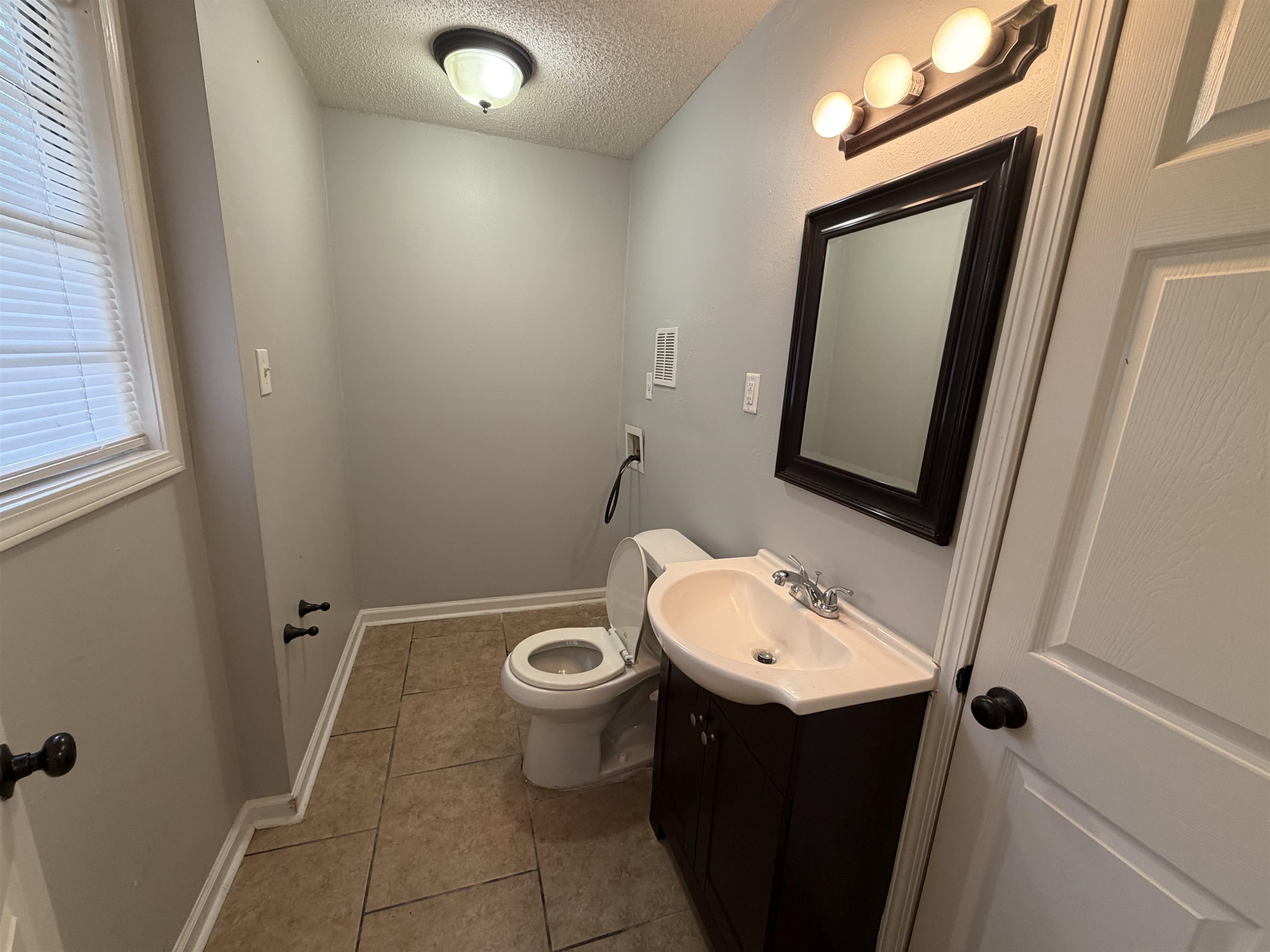 4073 Arrowhead Road Memphis, TN 38118 - Photo 4 of 10 a bathroom with a sink and a mirror