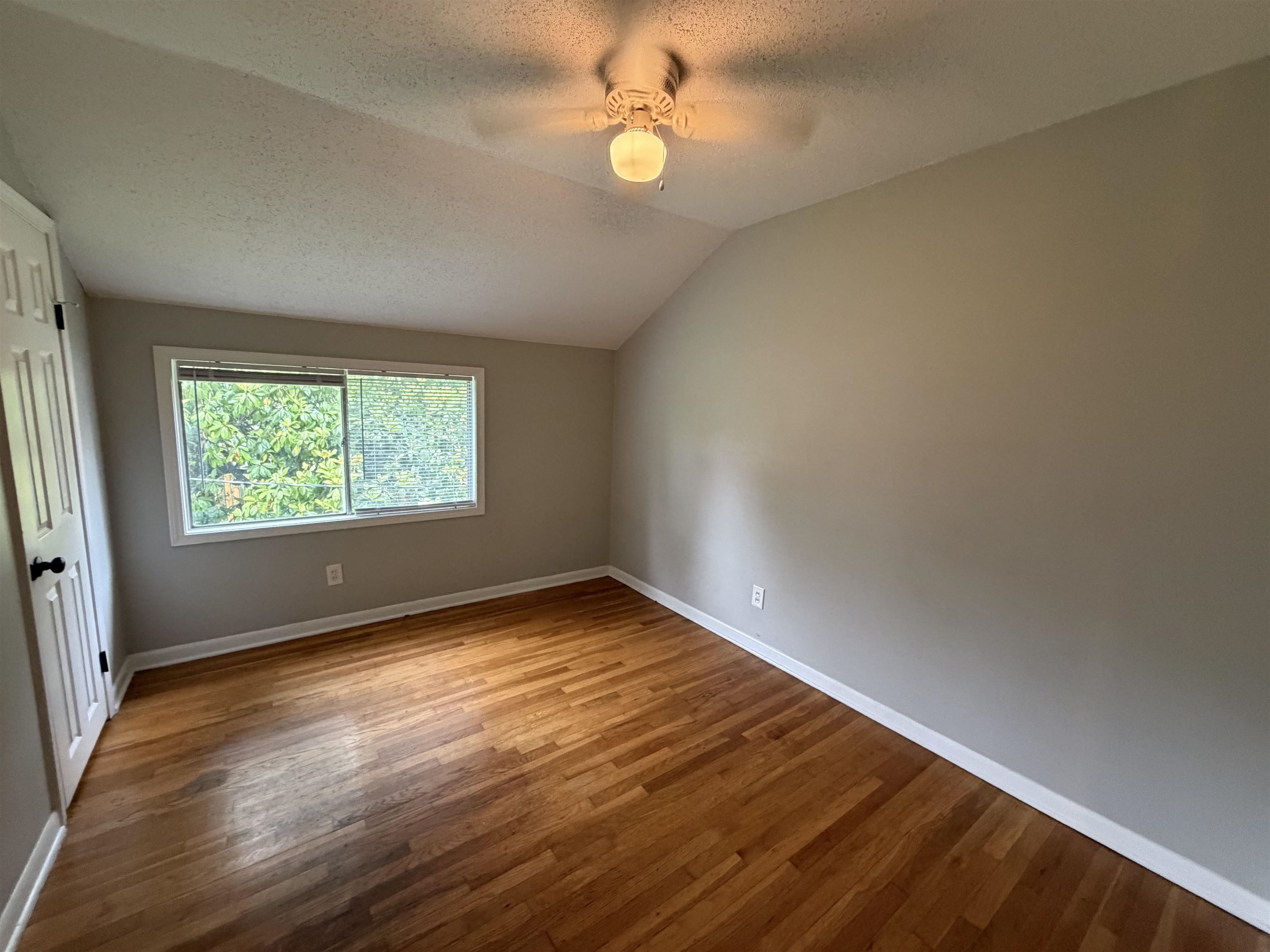4073 Arrowhead Road Memphis, TN 38118 - Photo 5 of 10 an empty room with wooden floor and windows