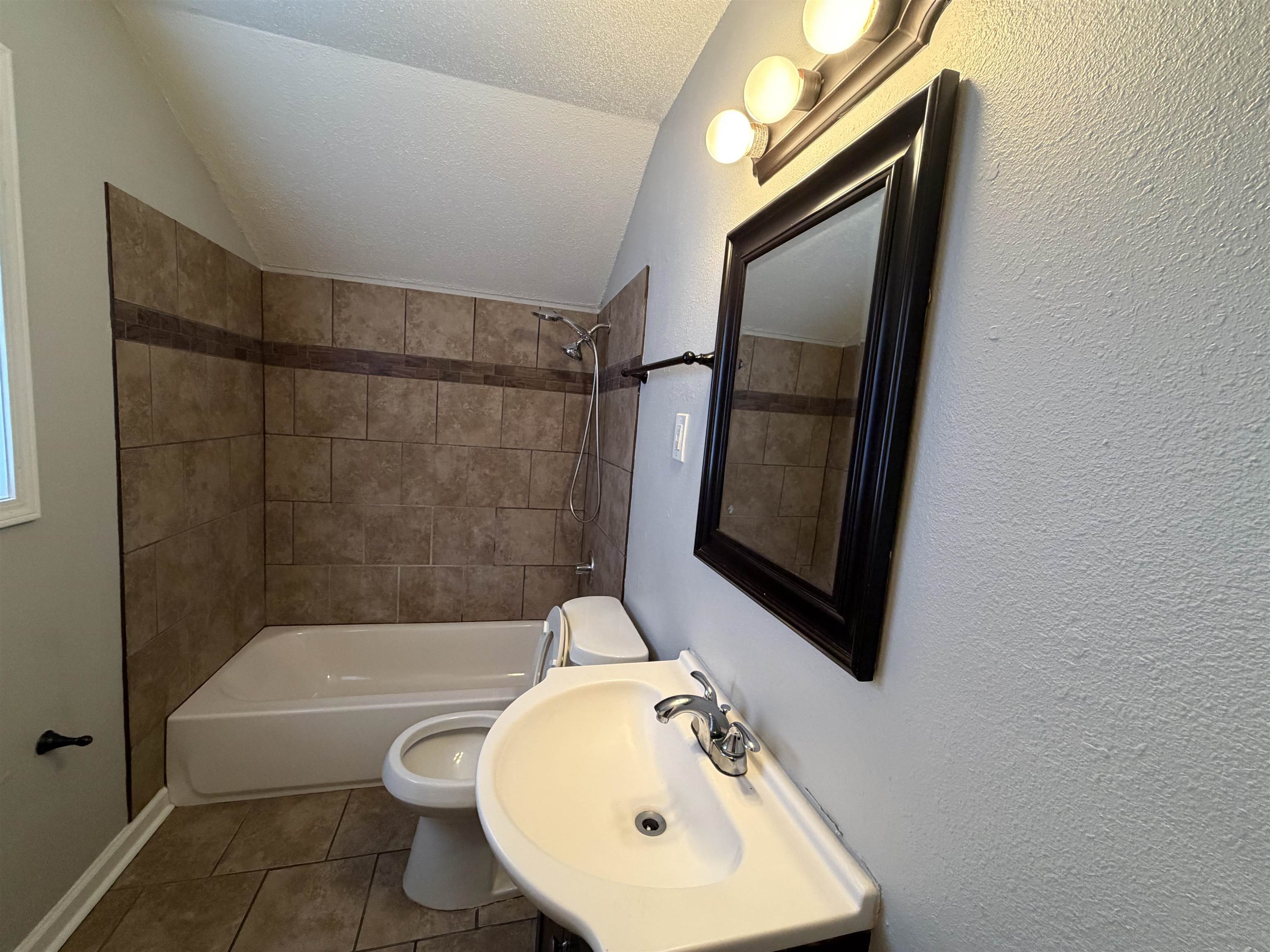 4073 Arrowhead Road Memphis, TN 38118 - Photo 6 of 10 a bathroom with a sink toilet and shower