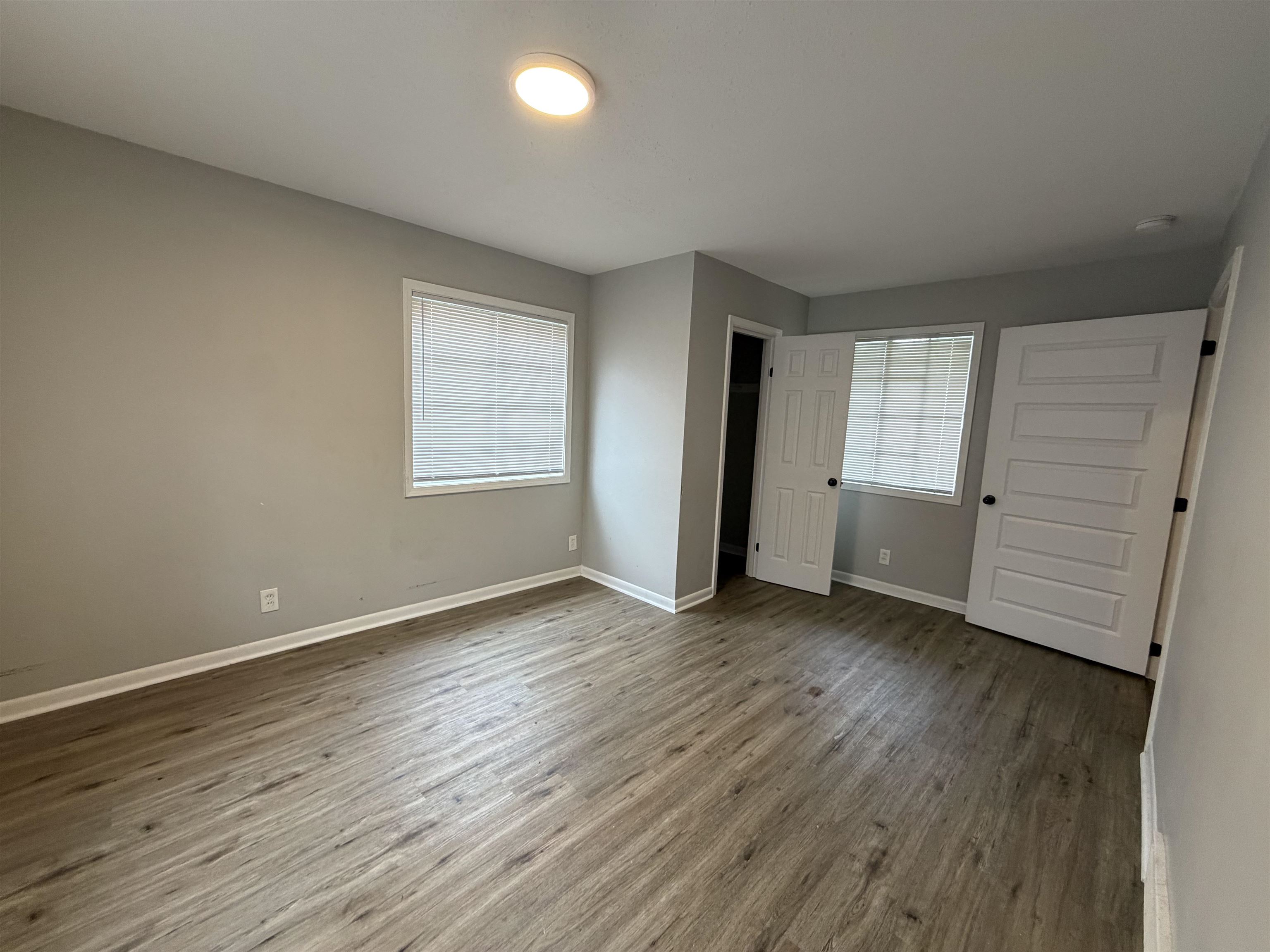 4073 Arrowhead Road Memphis, TN 38118 - Photo 9 of 10 an empty room with wooden floor and window