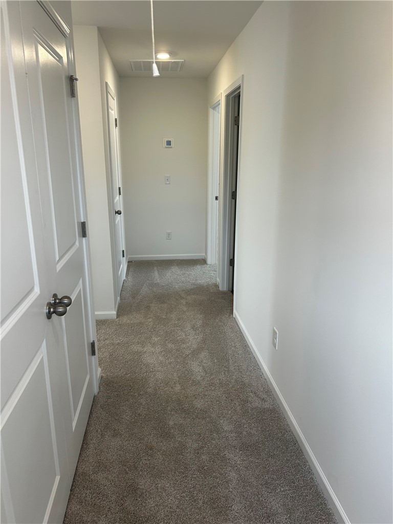 244 Brown Circle Easley, SC 29642 - Photo 15 of 16 This interior hallway offers easy access to multiple rooms, blending comfort and practicality.