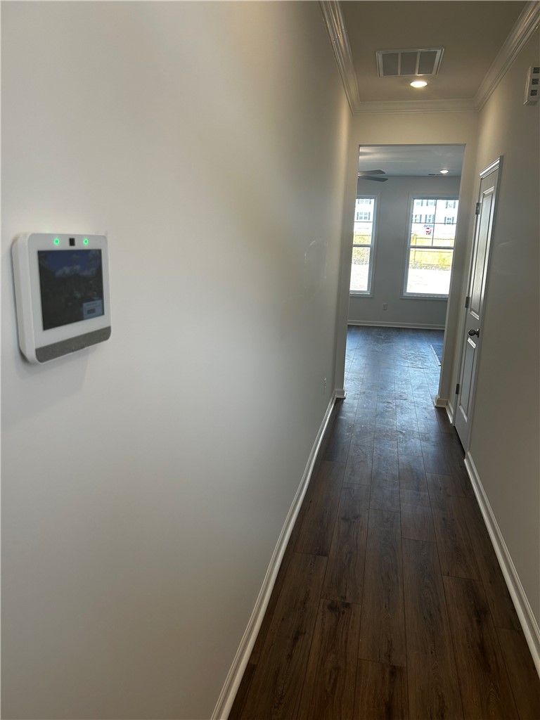 244 Brown Circle Easley, SC 29642 - Photo 4 of 16 This inviting hallway offers a warm welcome, connecting spaces with elegant flooring and architectural details.