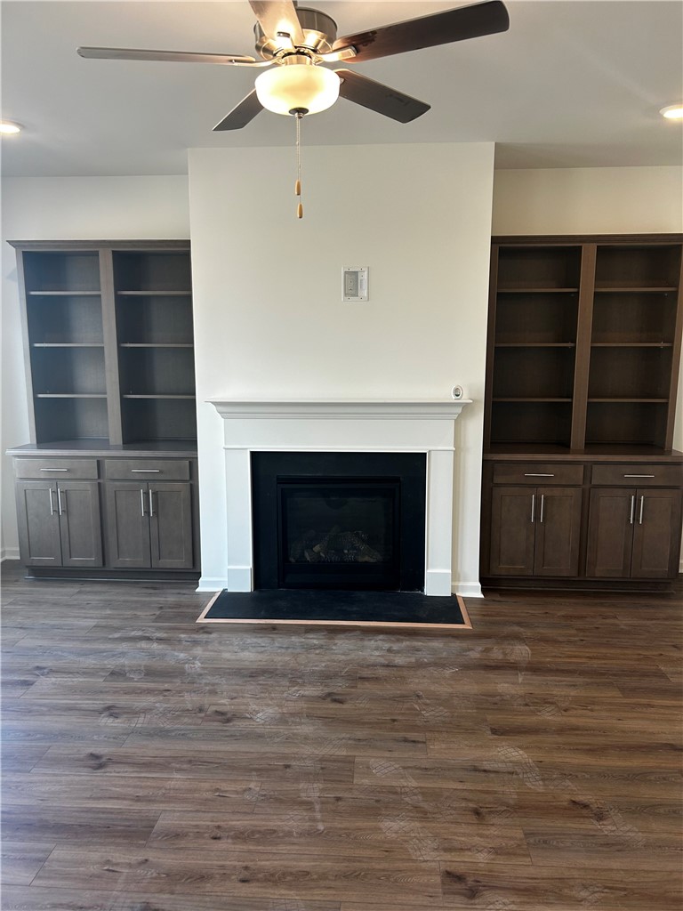 244 Brown Circle Easley, SC 29642 - Photo 5 of 16 This inviting living area features a fireplace with built-in shelving, creating a focal point for gatherings.