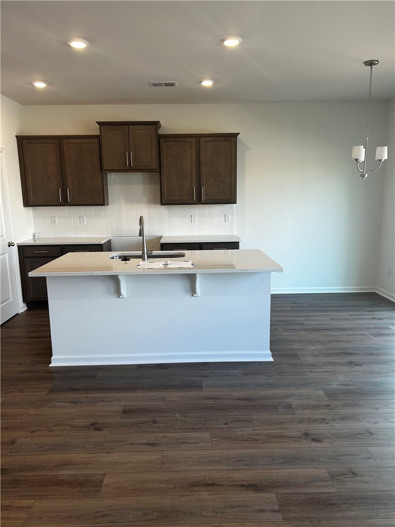 244 Brown Circle Easley, SC 29642 - Photo 6 of 16 This modern kitchen features rich cabinetry, sleek countertops, and an inviting island for culinary creativity.