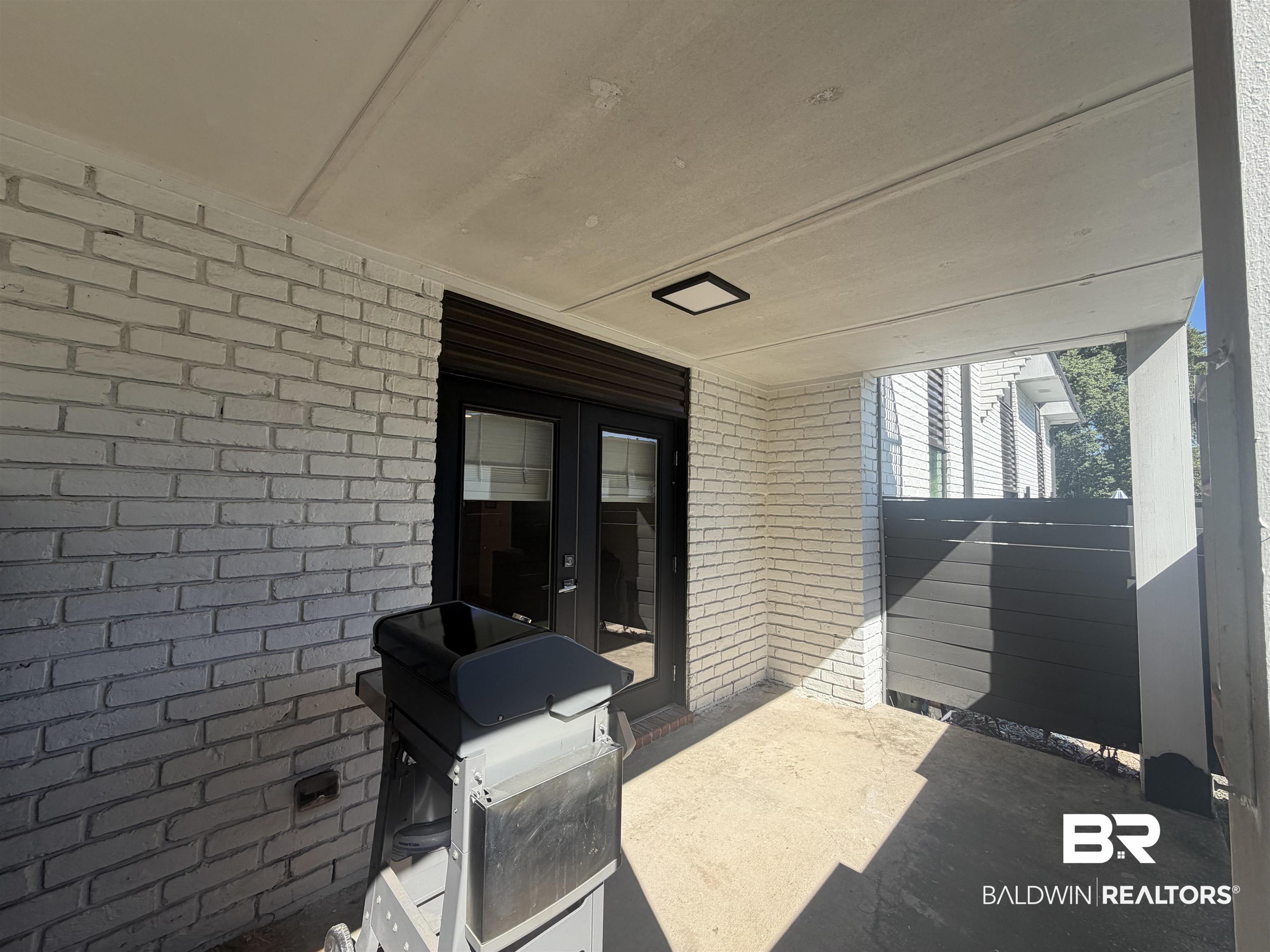 3655 Old Shell Road, Unit 219 Mobile, AL 36608 - Photo 14 of 25 View of patio with a grill and french doors