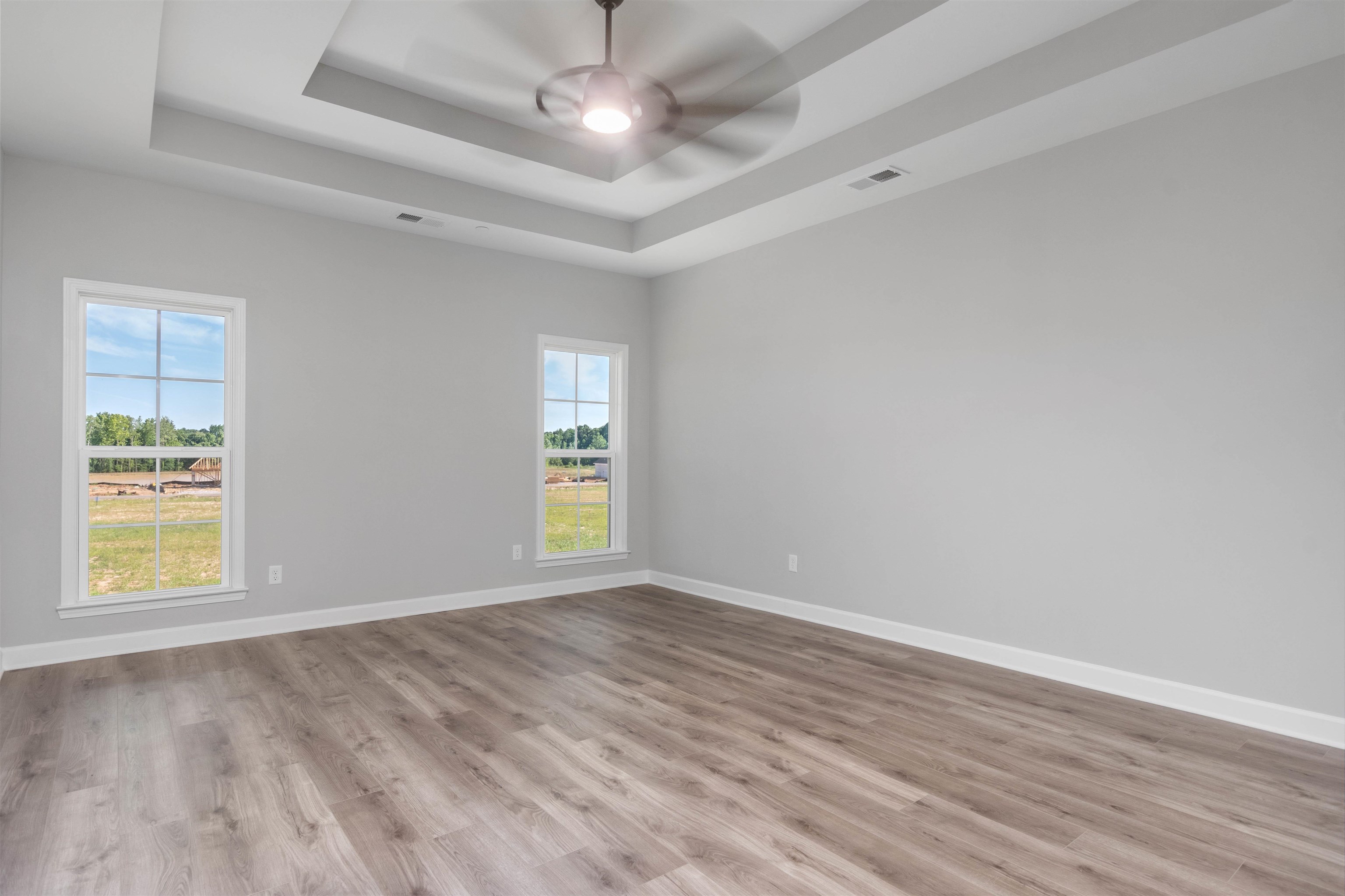 20 Grassy Hill Road Collierville, TN 38017 - Photo 11 of 27 wooden floor in an empty room with a window