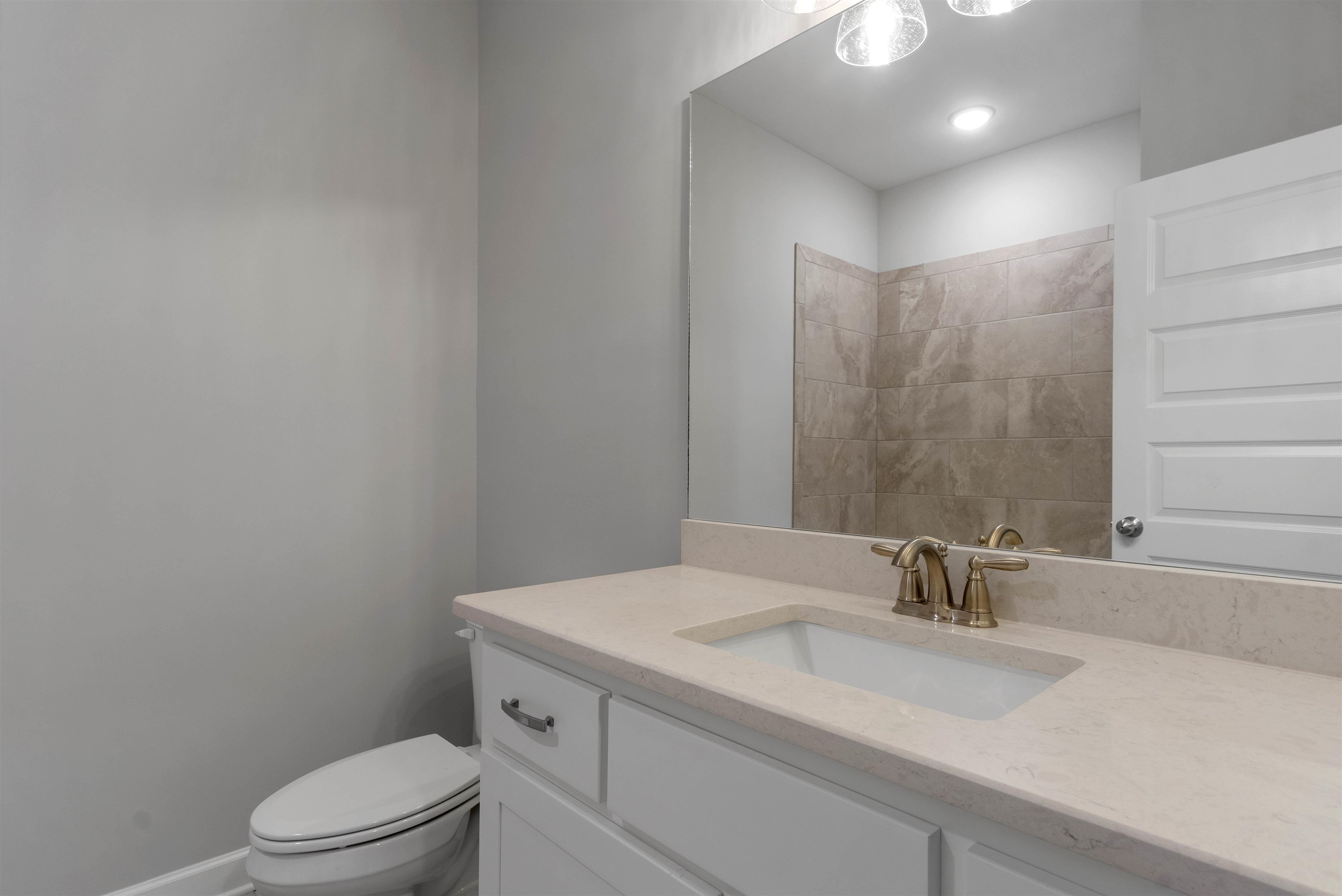 20 Grassy Hill Road Collierville, TN 38017 - Photo 18 of 27 a bathroom with a granite countertop sink a toilet and a mirror