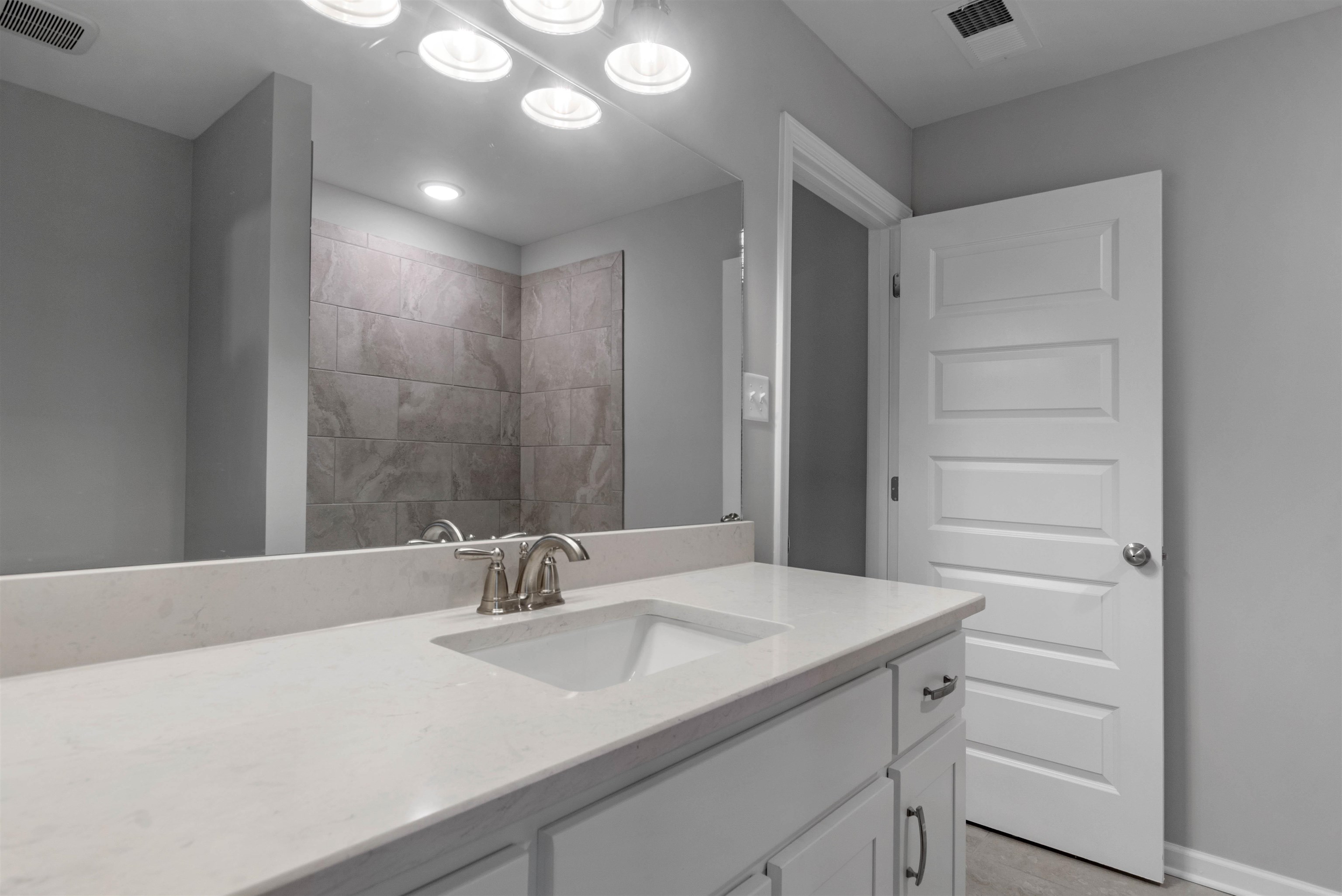 20 Grassy Hill Road Collierville, TN 38017 - Photo 21 of 27 a bathroom with a sink and a mirror