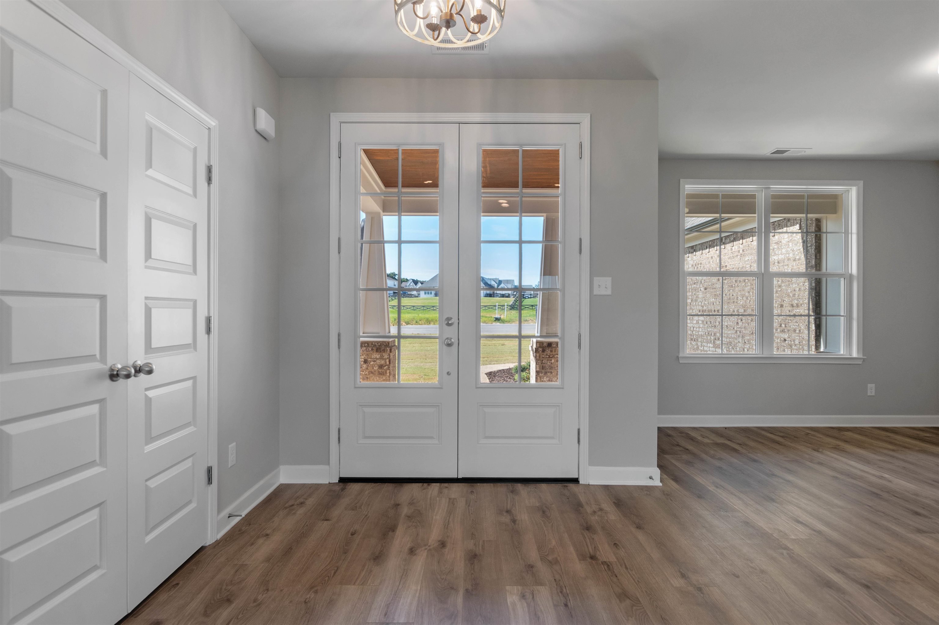 20 Grassy Hill Road Collierville, TN 38017 - Photo 4 of 27 an empty room with wooden floor and windows
