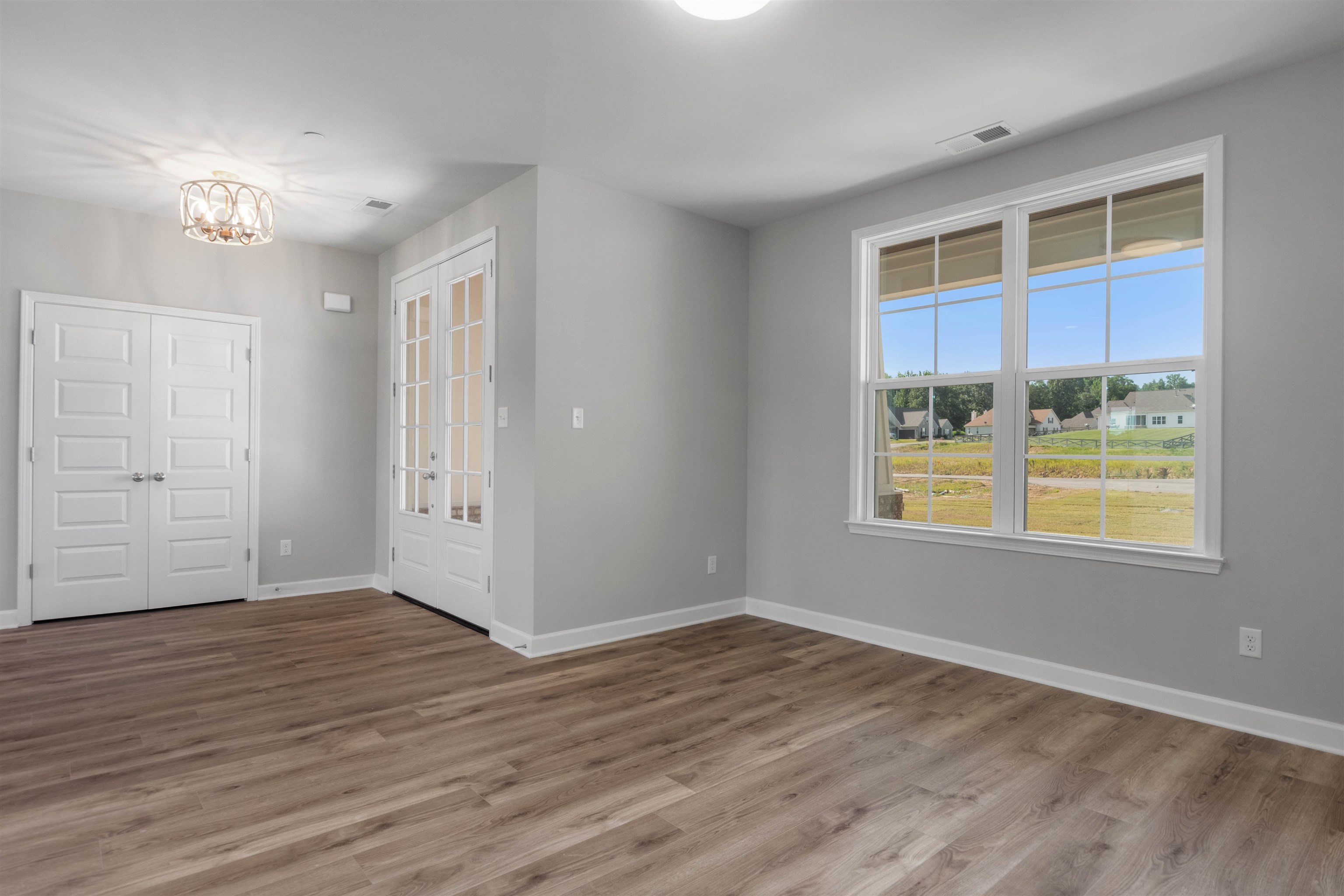 20 Grassy Hill Road Collierville, TN 38017 - Photo 5 of 27 a view of an empty room with wooden floor and a window