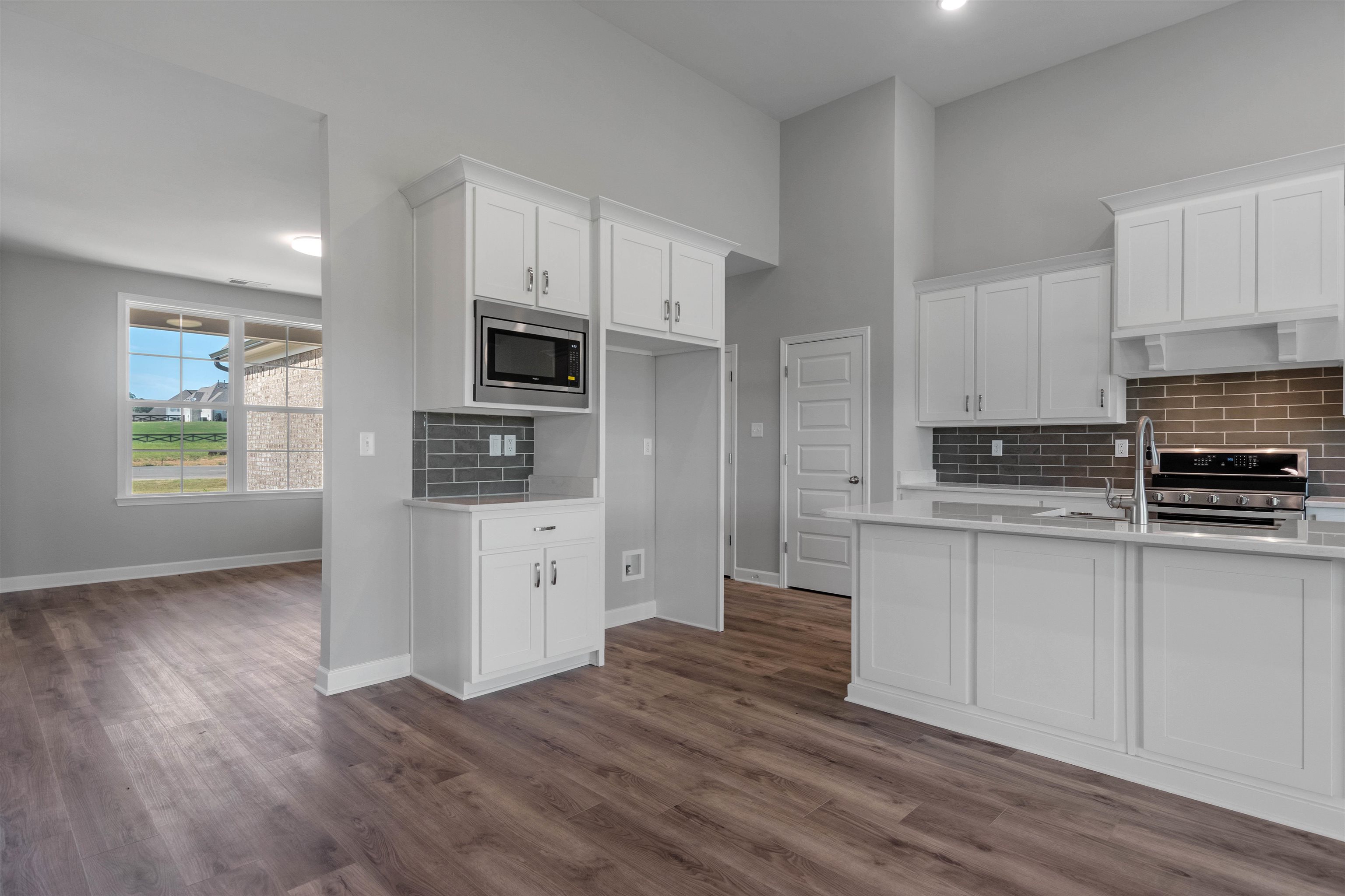 20 Grassy Hill Road Collierville, TN 38017 - Photo 9 of 27 a kitchen with granite countertop a refrigerator and a stove top oven
