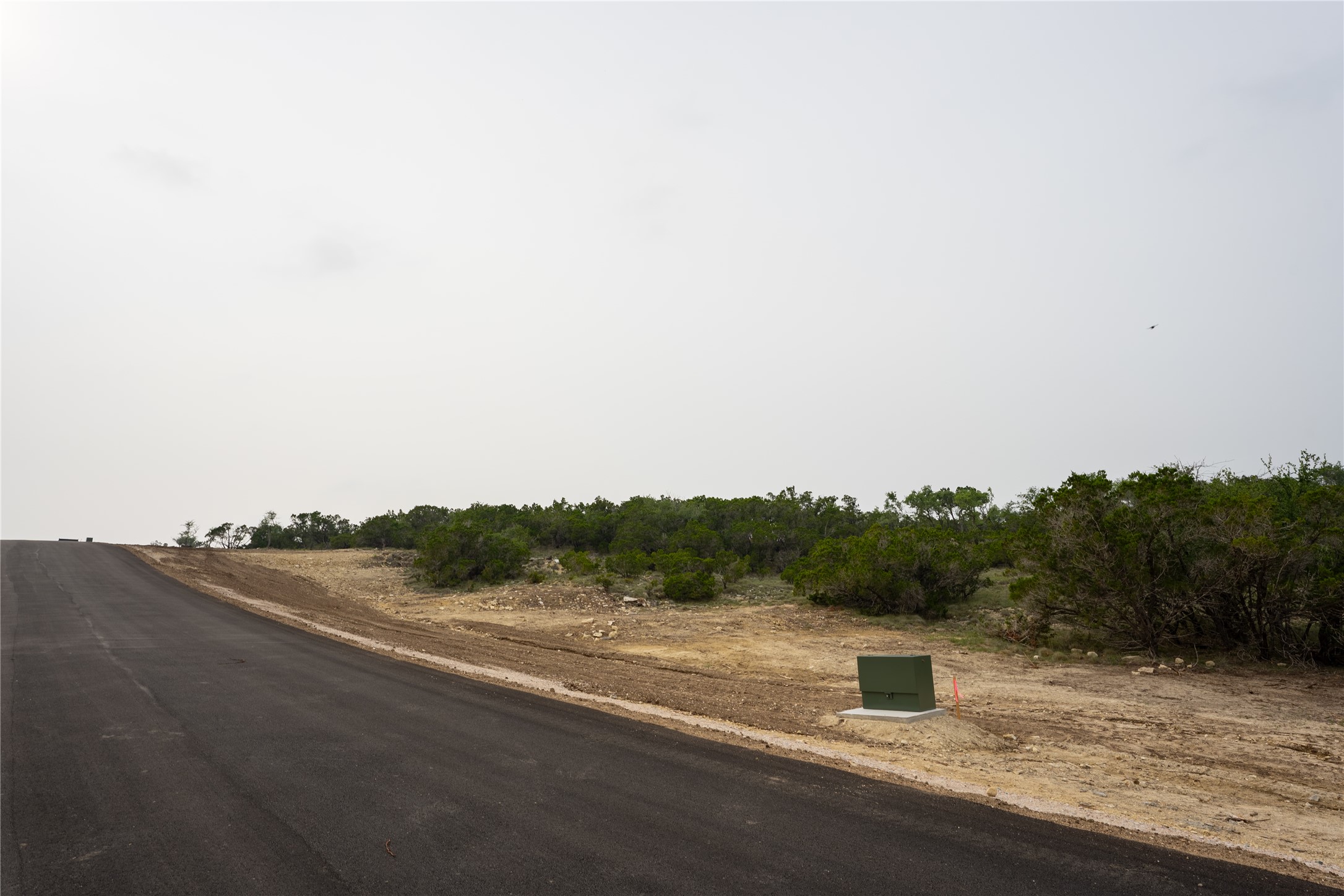 Lot 20 Ranch Road 165 Dripping Springs, TX 78620 - Photo 9 of 9 Paved road with utility box and natural vegetation