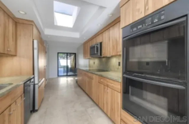 a kitchen with granite countertop a stove and a sink